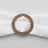 Gold circular napkin ring with crystal accents on a white napkin.