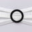 Black beaded oval hair accessory on white fabric backdrop.