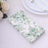 Floral patterned paper napkins featuring green leaves design