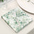 Eucalyptus-themed decorative napkins stacked on a table.