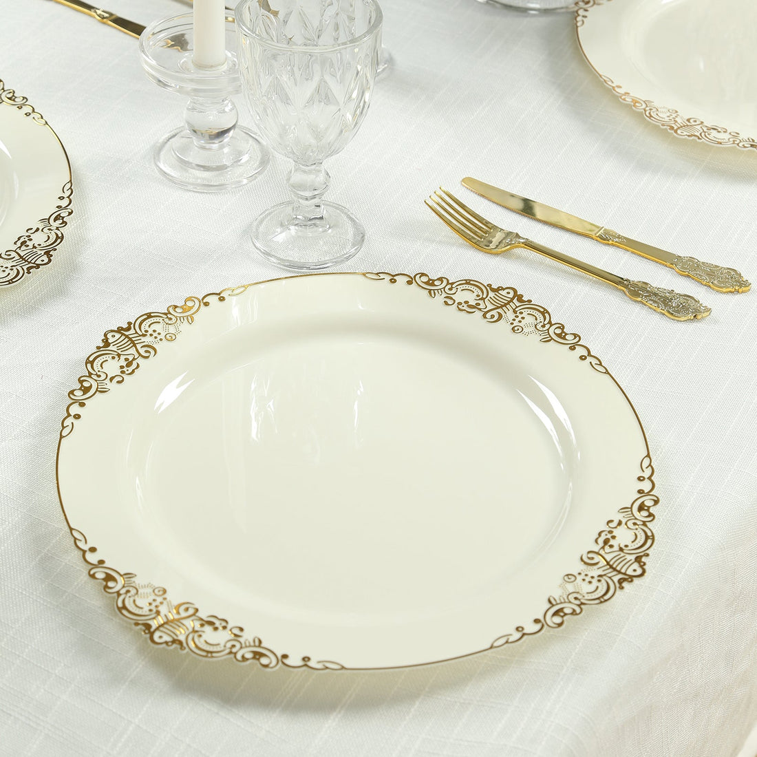 Elegant white dinner plate with gold intricate border design.