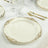 Elegant white dinner plate with gold intricate border design.