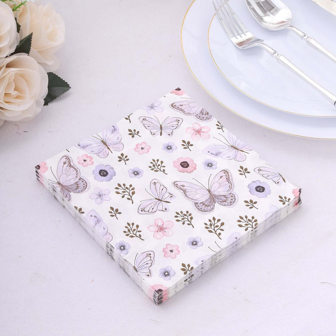 Floral butterfly-patterned paper napkins on a light surface.