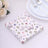 Floral butterfly-patterned paper napkins on a light surface.