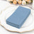 Stack of blue paper sheets on a decorative plate.