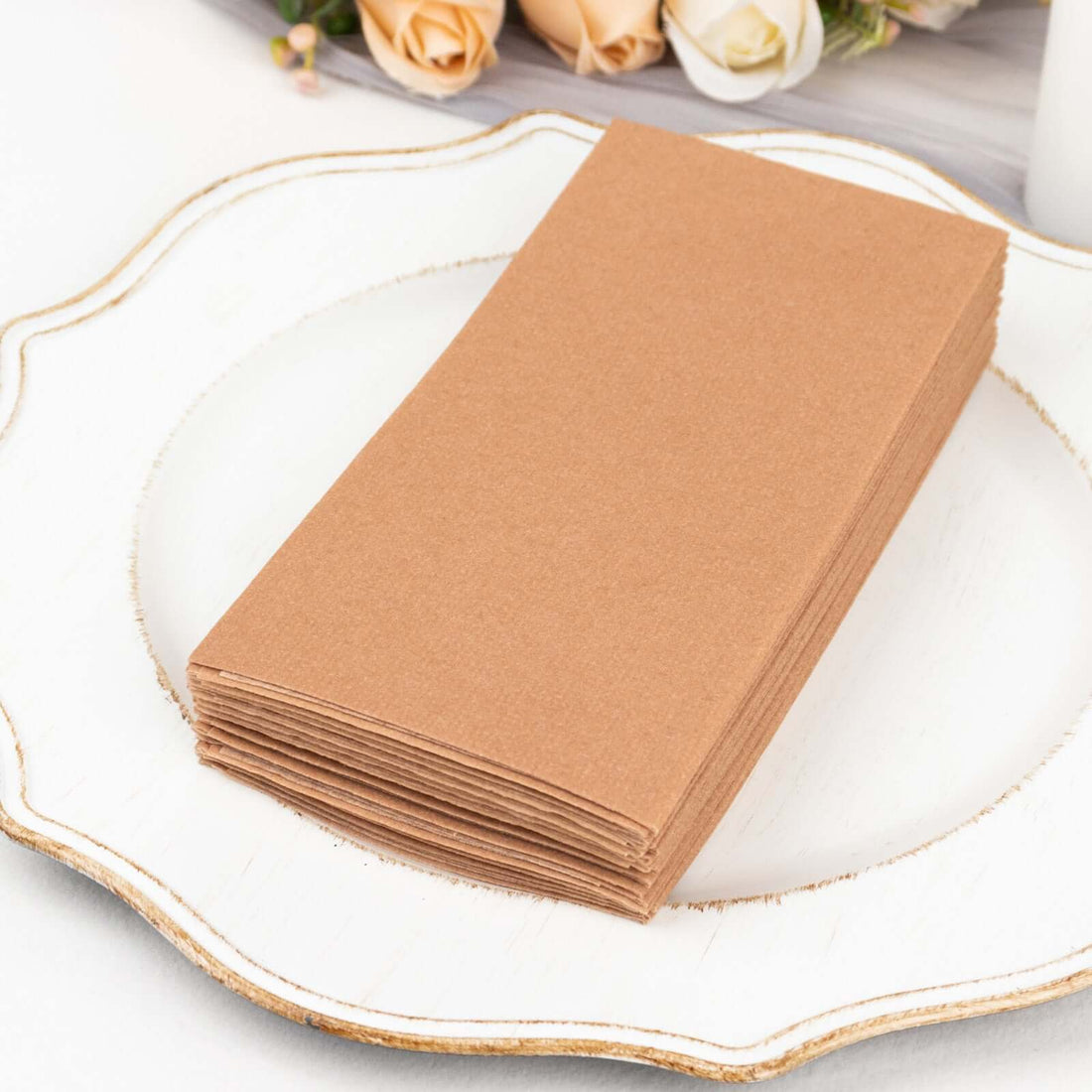 Stack of brown kraft paper sheets on a decorative plate.