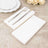 White napkins with silver fork and knife on a textured surface.