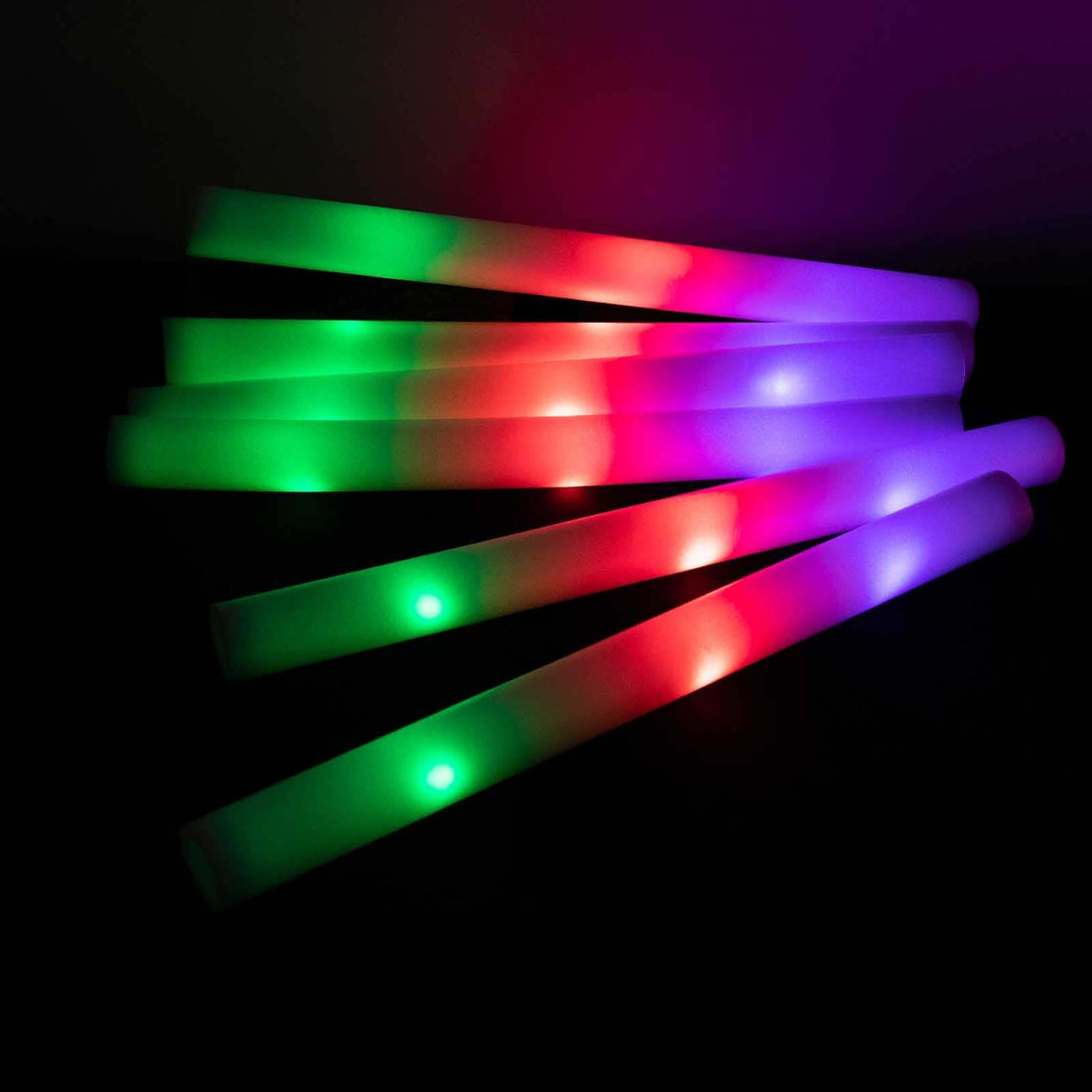 Colorful LED glow sticks in vibrant hues of green, red, and purple.