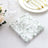Decorative floral napkins on a table setting with elegant dinnerware.