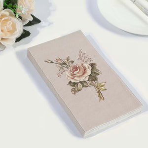 Embroidered rose design on a beige notebook against a white background