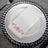 Elegant white napkin with floral design on a decorative plate.