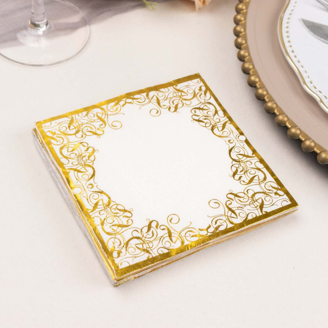 Elegant gold-foiled decorative napkin with intricate border design.