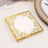 Elegant gold-foiled decorative napkin with intricate border design.