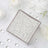 Clear glass decorative beads in a square container