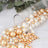 Assorted golden and white decorative pearls spilling from a glass jar.