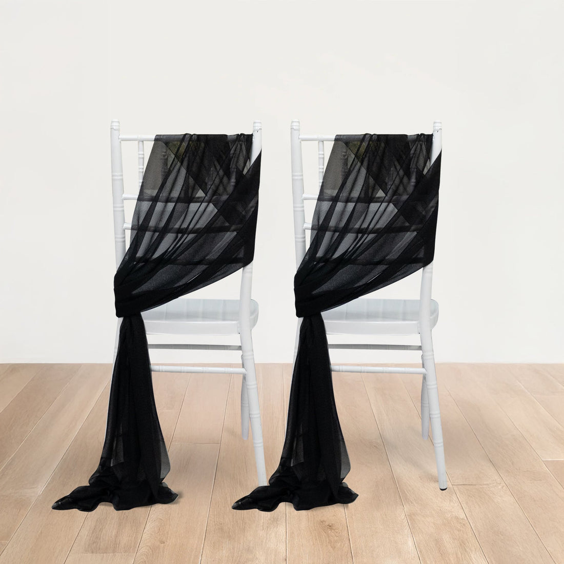 Black sheer chair sashes draped elegantly on white chiavari chairs