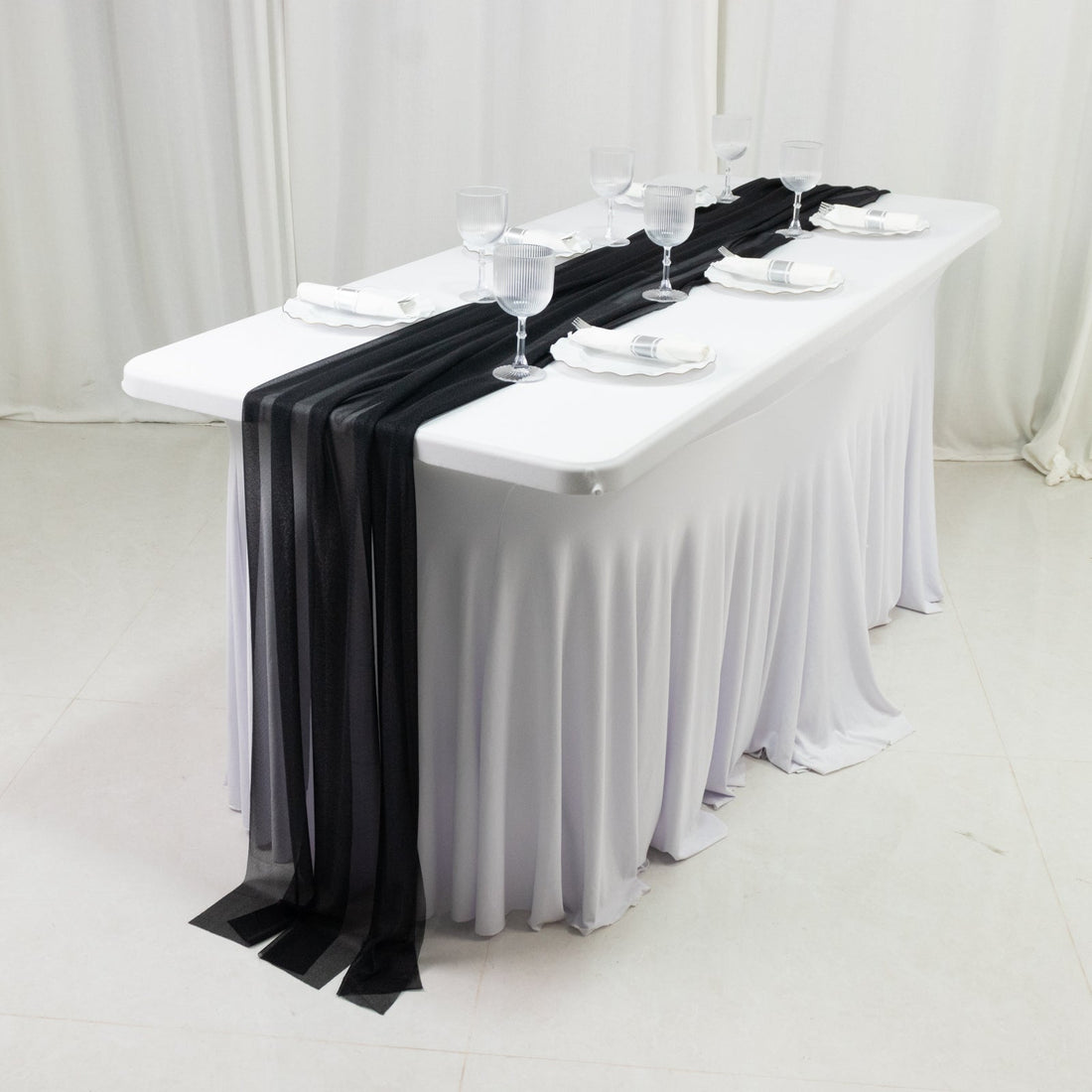 Elegant table setting with black and white decor for events or dining.
