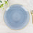 Blue ceramic plate with a gold rim on a light wooden surface.