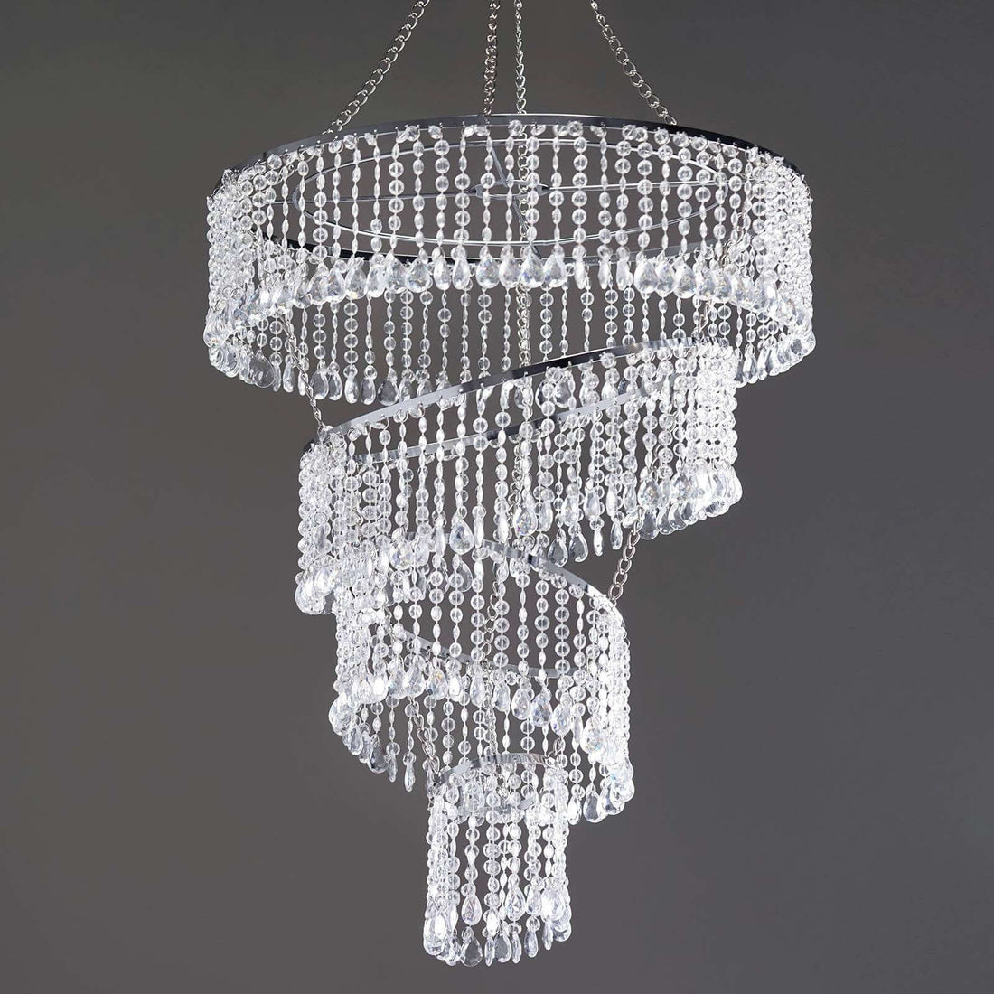 Elegant spiral crystal chandelier with cascading beads and chrome accents.