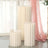 Modern cream-colored side tables with pleated design.