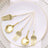 Elegant gold and white cutlery set arranged on a plate