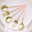 Gold and pink cutlery set on a white plate