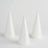 Three white conical crafting foam shapes on a plain background