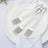 Set of three stainless steel forks on a white plate with napkin.