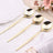 Set of three elegant gold spoons on a table setting.