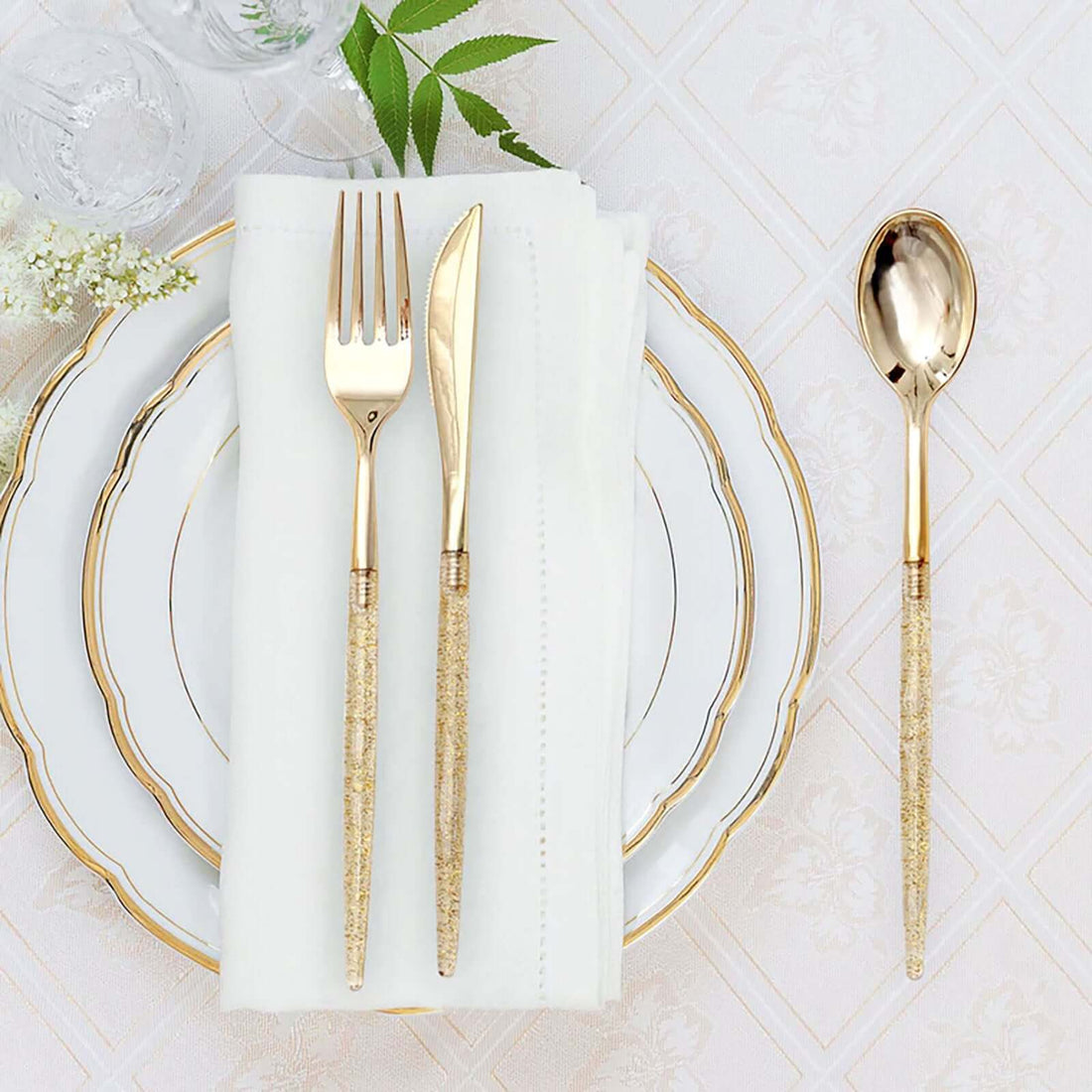 Elegant gold cutlery set on a decorative table setting.