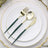 Elegant gold and green cutlery set on a white plate.