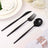 Black plastic cutlery set including knife, fork, and spoon on a table setting.