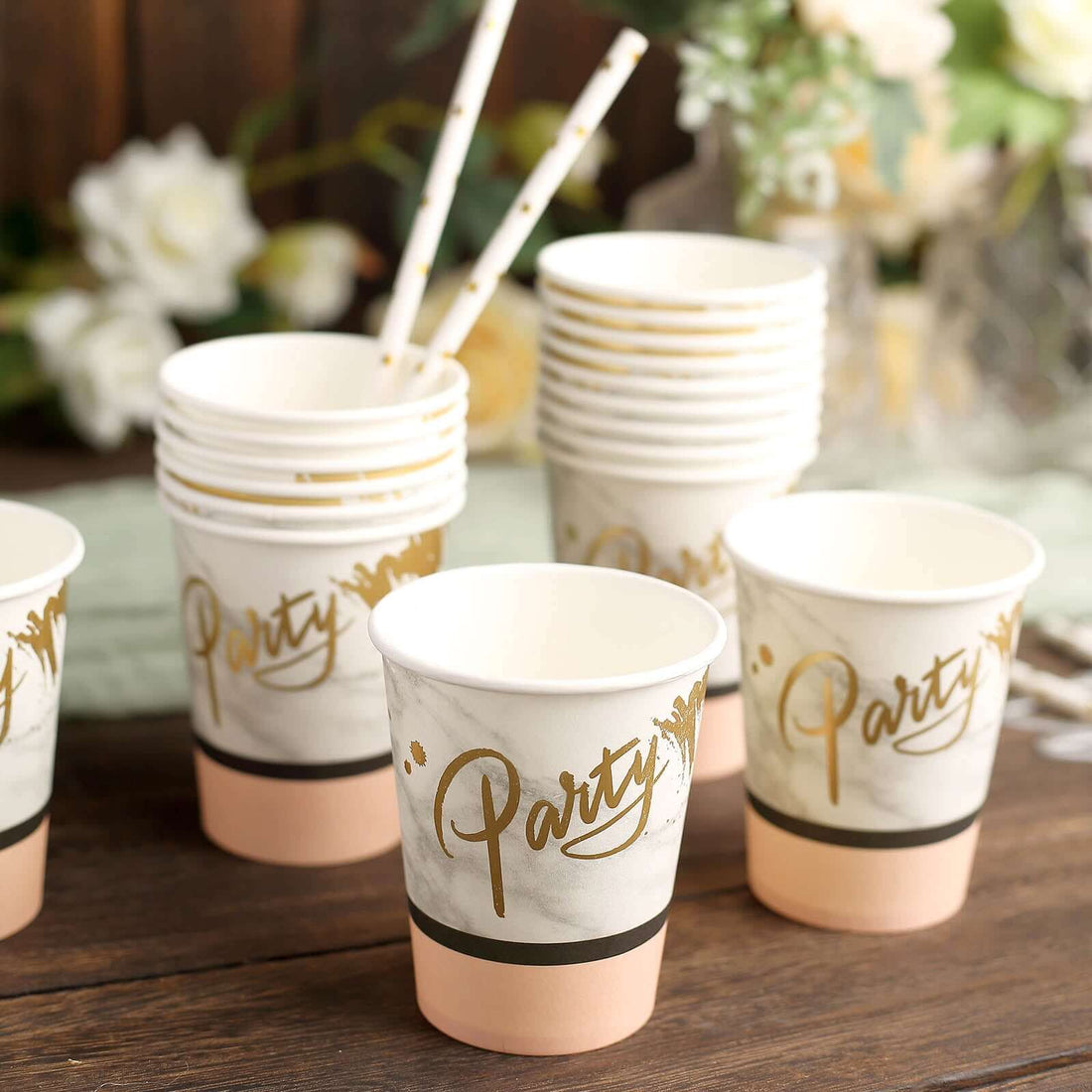 Party-themed disposable cups stacked with decorative straws.