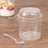 Clear plastic cup with lid and spoon on wooden surface.