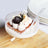 Delicious dessert with whipped cream, chocolate, and banana in a glass bowl.