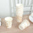 Stack of floral-patterned disposable cups on a wooden table.