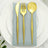 Gold cutlery set on a blue napkin, elegantly arranged on a white plate.