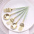 Elegant gold and mint green cutlery set on a white plate.