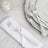 Set of elegant silver forks on a white napkin with plates in the background.