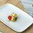 Dessert with ice cream, kiwi, and strawberry on a plate.
