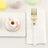 Decorative donut on a plate with a fork and napkin