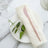 Elegant table setting with a pink knife on a white plate and napkin.