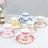 Colorful decorative cups and saucers in various floral designs.