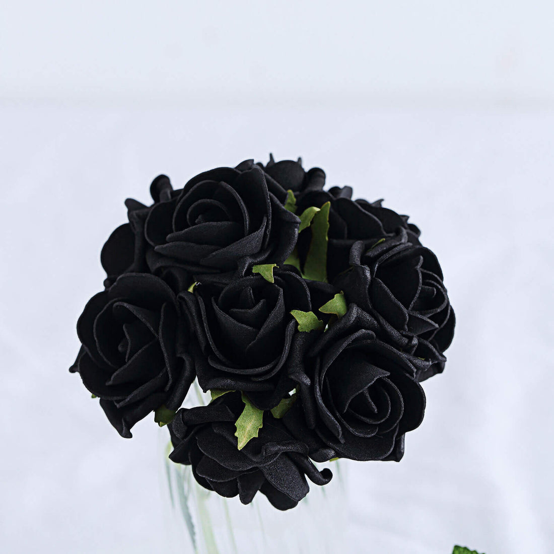 Black rose bouquet in a glass vase.