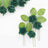 Green artificial roses with leaves on a white background.