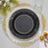 Elegant black and gold decorative plate with intricate design details.