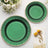 Set of elegant green plates with gold trim, styled with flowers.