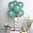 Teal balloons arranged as a decorative centerpiece with flowers and fruit.