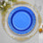 Blue decorative plate with gold trim on a white background