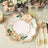 Floral decorative plate with gold trim on a styled table setting.